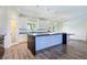 Modern kitchen boasts a spacious island, pendant lighting, and stylish white cabinetry at 5500 Santovito St, Pahrump, NV 89061