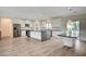 Spacious kitchen features modern appliances, large island with dark countertops, and natural light from sliding glass doors at 5500 Santovito St, Pahrump, NV 89061