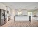 Spacious kitchen features a large island with dark countertops, and stainless steel appliances at 5500 Santovito St, Pahrump, NV 89061