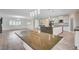 Open concept kitchen with island, white cabinets, and modern finishes at 5500 Santovito St, Pahrump, NV 89061