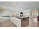Open floor plan features a kitchen with a large island and modern lighting at 5500 Santovito St, Pahrump, NV 89061