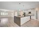 Bright kitchen features a large island, white cabinetry, and modern appliances at 5500 Santovito St, Pahrump, NV 89061