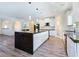 Open kitchen design with a large island, black countertops, and seamless transition to living spaces at 5500 Santovito St, Pahrump, NV 89061