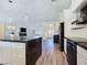 Open-concept kitchen showcasing a large island, black countertops, and seamless flow to the living area at 5500 Santovito St, Pahrump, NV 89061