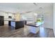 Expansive kitchen with an island, white cabinets, black countertops, with a large dining area at 5500 Santovito St, Pahrump, NV 89061