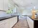 Spacious kitchen featuring white cabinets, black counters, and seamless flow to the dining area at 5500 Santovito St, Pahrump, NV 89061