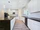 Large kitchen showcases a spacious island, white cabinets, black countertops, and modern fixtures at 5500 Santovito St, Pahrump, NV 89061
