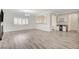 A living room featuring hardwood floors and a dry bar area creates an open and inviting living space at 5500 Santovito St, Pahrump, NV 89061
