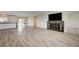 Bright living space with hardwood floors adjoins a modern kitchen, offering an open and airy atmosphere at 5500 Santovito St, Pahrump, NV 89061