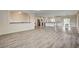 A modern kitchen adjoins an open living space, featuring hardwood floors and modern design elements at 5500 Santovito St, Pahrump, NV 89061