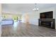 Open living room with fireplace, backyard access, and bar area, creating a welcoming flow for gatherings at 5500 Santovito St, Pahrump, NV 89061