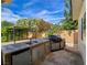 Inviting outdoor kitchen with stainless steel grill, sink, and granite countertops perfect for outdoor entertaining at 5500 Santovito St, Pahrump, NV 89061