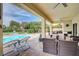 Enjoy outdoor living on this covered patio, featuring a view of the refreshing pool and lush landscaping at 5500 Santovito St, Pahrump, NV 89061