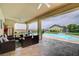Inviting covered patio with ample seating overlooks the sparkling pool and beautifully landscaped backyard at 5500 Santovito St, Pahrump, NV 89061