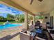 An exceptional backyard patio with ample seating, a grill, and access to a sparkling pool at 5500 Santovito St, Pahrump, NV 89061