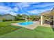 Refreshing backyard pool is surrounded by green space, seating and offers a relaxing oasis at 5500 Santovito St, Pahrump, NV 89061