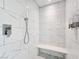 Luxurious stand up shower with white marble tile and built in seat at 5500 Santovito St, Pahrump, NV 89061
