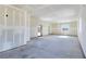 Large unfinished room with drywall and concrete floors, with multiple windows and entrances at 5500 Santovito St, Pahrump, NV 89061