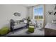 Cozy secondary bedroom perfect as a Bedroom with a crib, chair, and decorative elements at 5773 Crenellated St # Lot 57, Las Vegas, NV 89148