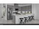 Contemporary kitchen with gray cabinetry, stainless steel appliances, and a stylish breakfast bar at 5773 Crenellated St # Lot 57, Las Vegas, NV 89148