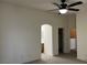 Neutral bedroom showcasing archway and connections to bathroom and closets at 6462 Saddle Up Ave # 103, Henderson, NV 89011