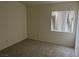 Simple bedroom with neutral carpet, window, and natural light at 6462 Saddle Up Ave # 103, Henderson, NV 89011