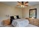 Cozy bedroom with neutral walls, ceiling fan, and a comfortable bed with soft linens at 6463 Big Pine Way, Las Vegas, NV 89108