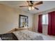 Bedroom with neutral walls, ceiling fan, and a comfortable bed with colorful linens at 6463 Big Pine Way, Las Vegas, NV 89108