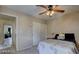 Bedroom with neutral walls, ceiling fan, and a comfortable bed with soft linens and closet at 6463 Big Pine Way, Las Vegas, NV 89108