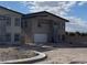 New construction home with modern design elements and a two-car garage, under a blue sky at 6527 Adrian Ridge Ct, Las Vegas, NV 89149