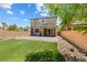 Extensive backyard featuring lush lawn, rock accents, and a brick-paved patio that is accessible from inside the house at 6783 Pleasant Flower St, Las Vegas, NV 89149