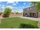 Large back yard with lush green lawn, rock landscaping, and brick-paved patio for easy access from the home at 6783 Pleasant Flower St, Las Vegas, NV 89149