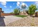 Spacious backyard with pristine lawn, rock landscaping, and a brick-paved patio area, ideal for outdoor living at 6783 Pleasant Flower St, Las Vegas, NV 89149