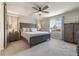 Relaxing bedroom with king bed, ceiling fan, side tables, and beautiful natural light at 6783 Pleasant Flower St, Las Vegas, NV 89149