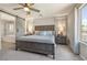 Tranquil bedroom with king bed, ceiling fan, side tables, a barn door to bathroom and natural light at 6783 Pleasant Flower St, Las Vegas, NV 89149