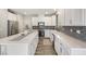 Bright kitchen with white cabinets, stainless steel appliances, mosaic backsplash and a large island with a seating area at 6783 Pleasant Flower St, Las Vegas, NV 89149