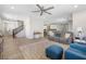 Open-concept living space with tile floors connecting to the kitchen and dining area at 6783 Pleasant Flower St, Las Vegas, NV 89149