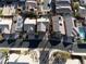 Drone shot of a suburban neighborhood with neatly arranged homes, desert landscaping, and community pools at 74 Harbor Coast St, Las Vegas, NV 89148