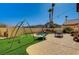 Backyard with artificial turf, a pool, a play set and a patio area, perfect for outdoor activities at 74 Harbor Coast St, Las Vegas, NV 89148