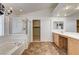 Bathroom featuring a soaking tub, glass enclosed shower, and double sink vanity at 74 Harbor Coast St, Las Vegas, NV 89148
