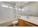 Well-lit bathroom featuring a bathtub, shower, and a vanity with a large mirror, offering functionality at 74 Harbor Coast St, Las Vegas, NV 89148