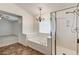 Bright bathroom with a soaking tub, glass enclosed shower, chandelier and natural light at 74 Harbor Coast St, Las Vegas, NV 89148