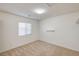 Empty bedroom with carpet flooring, a window and neutral colored walls at 74 Harbor Coast St, Las Vegas, NV 89148