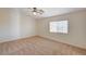 Spacious bedroom with neutral walls, carpet flooring, a ceiling fan and a bright window at 74 Harbor Coast St, Las Vegas, NV 89148