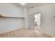 Walk-in closet boasting carpet flooring, a hanging rod for clothes, and slider door entrance at 74 Harbor Coast St, Las Vegas, NV 89148