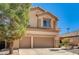 Home exterior featuring a two-car garage, and front yard landscaping at 74 Harbor Coast St, Las Vegas, NV 89148