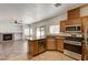 Open kitchen with island and stainless steel appliances, flowing into living area at 74 Harbor Coast St, Las Vegas, NV 89148