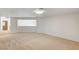 Large living area featuring neutral carpet, bright natural light, and open floorplan at 74 Harbor Coast St, Las Vegas, NV 89148