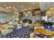 Elegant lounge area with a stone fireplace, chandelier, and comfortable seating at 74 Harbor Coast St, Las Vegas, NV 89148