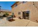 Back patio featuring a dining table and access to the home via sliding glass doors, ideal for outdoor entertaining at 74 Harbor Coast St, Las Vegas, NV 89148